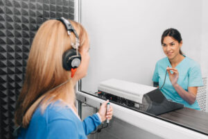 A doctor checking a commercial driver's hearing