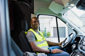 A commercial driver sits in their vehicle reflecting on their successful commercial drivers license skills tests.