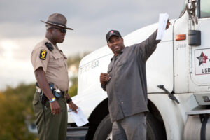 A truck driver receiving a fine for violating hours of service regulations